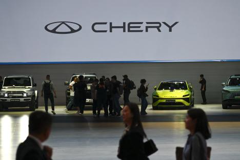 People viewing Chery cars at an auto show.
