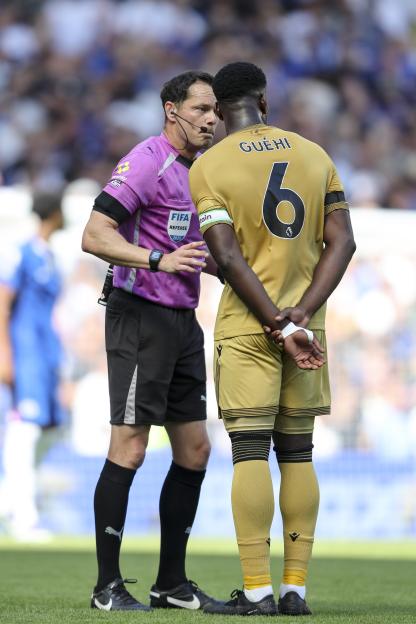 Referee speaking to Marc Guéhi of Crystal Palace.