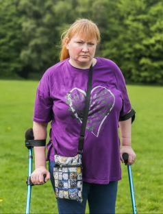 Woman with crutches, scammed out of money online.
