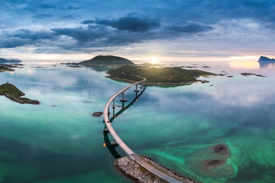 Aerial view of a bridge over turquoise water and islands.