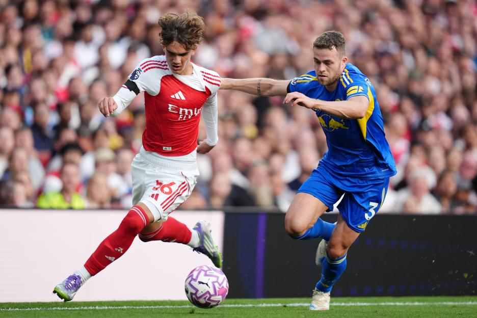 Arsenal's Max Dowman and Leeds United's Gabriel Gudmundsson vying for the ball during a Premier League match.