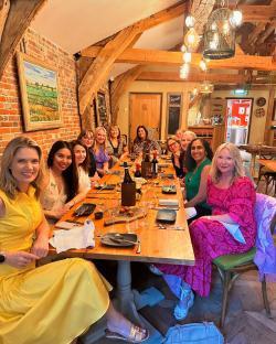 Group of women at a dinner table.