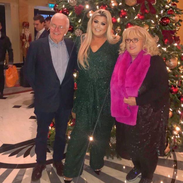 Gemma Collins with her parents in front of a Christmas tree.