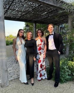 Four people in formal attire posing for a photo.