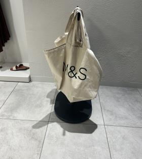 M&S tote bags on display.