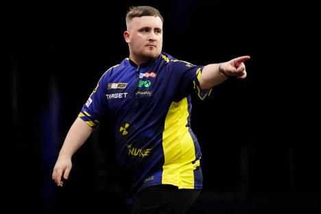 Luke Littler playing darts.