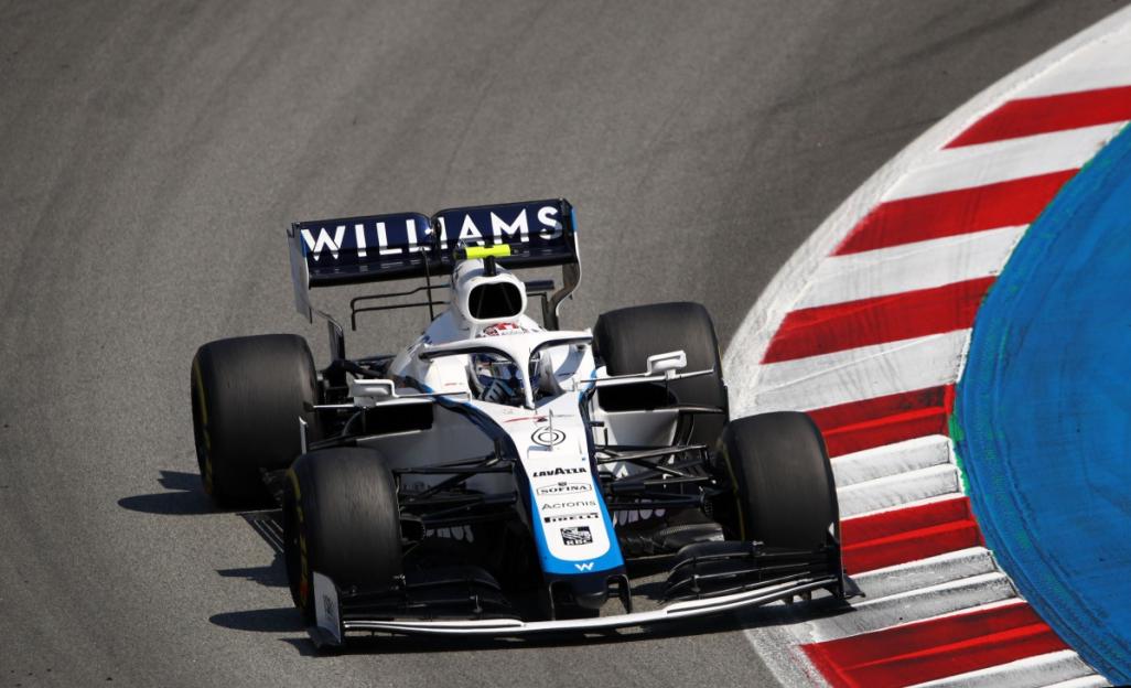 A Williams Formula 1 car navigating a turn on a track.