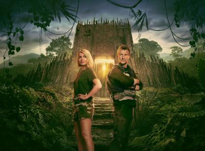 Promotional image of Holly Willoughby and Bear Grylls in front of a jungle structure.
