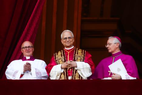 Pope Leo XIV and two other cardinals on a balcony.