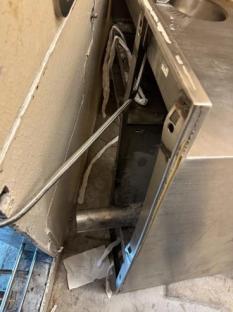 Damaged stainless steel facility equipment.