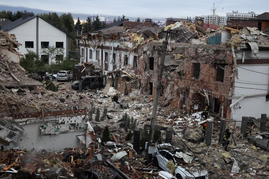 Emergency workers operate at a residential impact site after missile attacks in Kyiv, Ukraine.