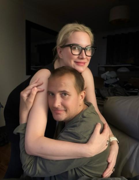 Woman hugging man from behind.