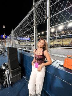 McLaren F1 racer Bianca Bustamante at a racetrack.