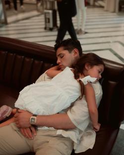 A man and young girl sleeping on a couch.