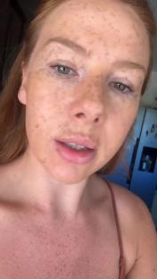 Close-up of a woman's face and upper chest.