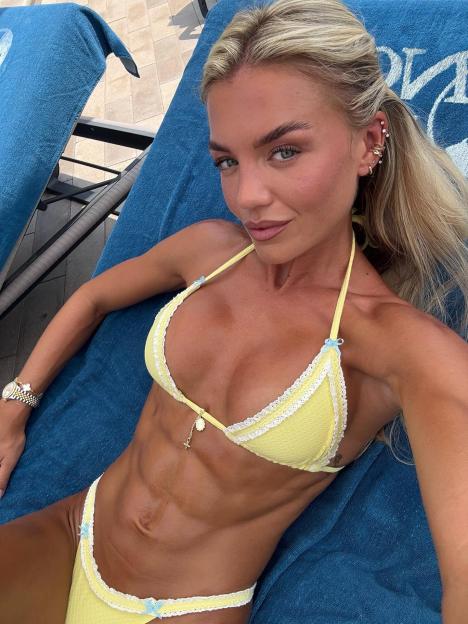 Molly Smith shows off toned abs in a yellow bikini.