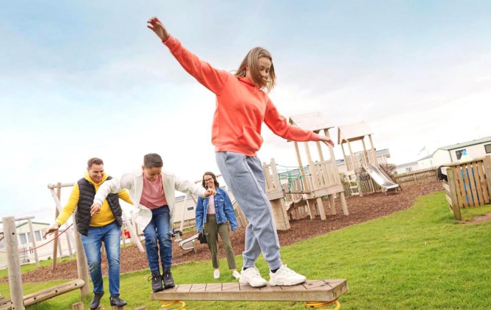 Family having fun at an outdoor playground.