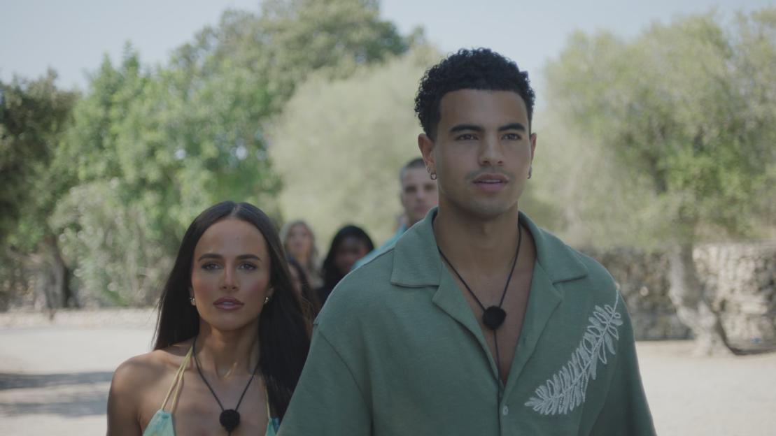 Lauren and Harrison from Love Island walking outdoors.