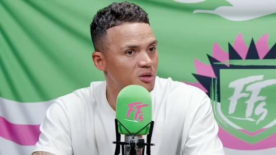 Jermaine Jenas speaking into a microphone.