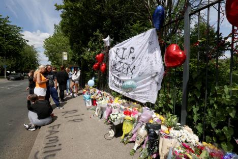 Floral tributes and messages at a memorial for two teenage boys.