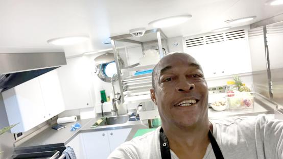 Selfie of a smiling chef in a galley.
