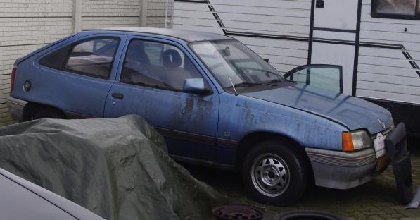 A weathered blue 1986 Opel Kadett E.