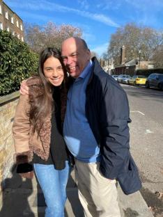A man and a young woman smiling for a photo.