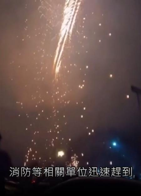 Fireworks performance with sparks raining down over the crowd.
