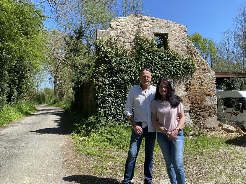 Tony and Terry standing in front of old building ruins.