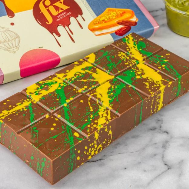Chocolate bar with green and yellow splatter design.