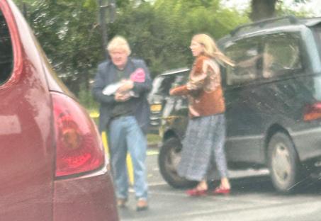 Boris Johnson and Carrie Johnson with their baby leaving a store.