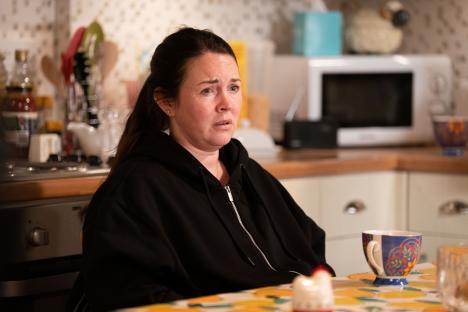 Stacey Slater from EastEnders in a kitchen, looking worried.
