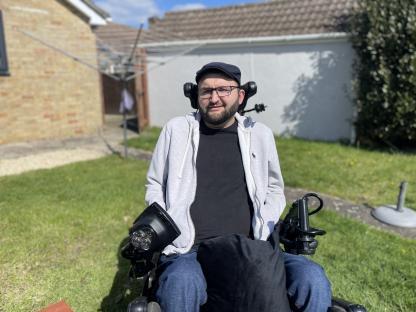 Man in wheelchair outdoors.