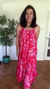 Woman in a red floral maxi dress.