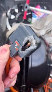 Damaged electrical plug with melted wires.