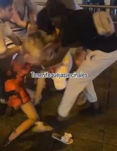Two women fighting on a street.