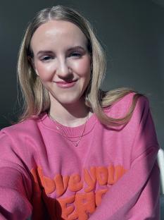 Woman in pink sweatshirt with