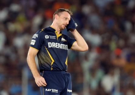 Jos Buttler of the Gujarat Titans wipes his brow during a cricket match.