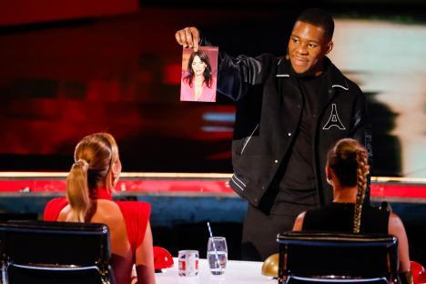 A man holding up a photo of Amanda Holden on Britain's Got Talent.