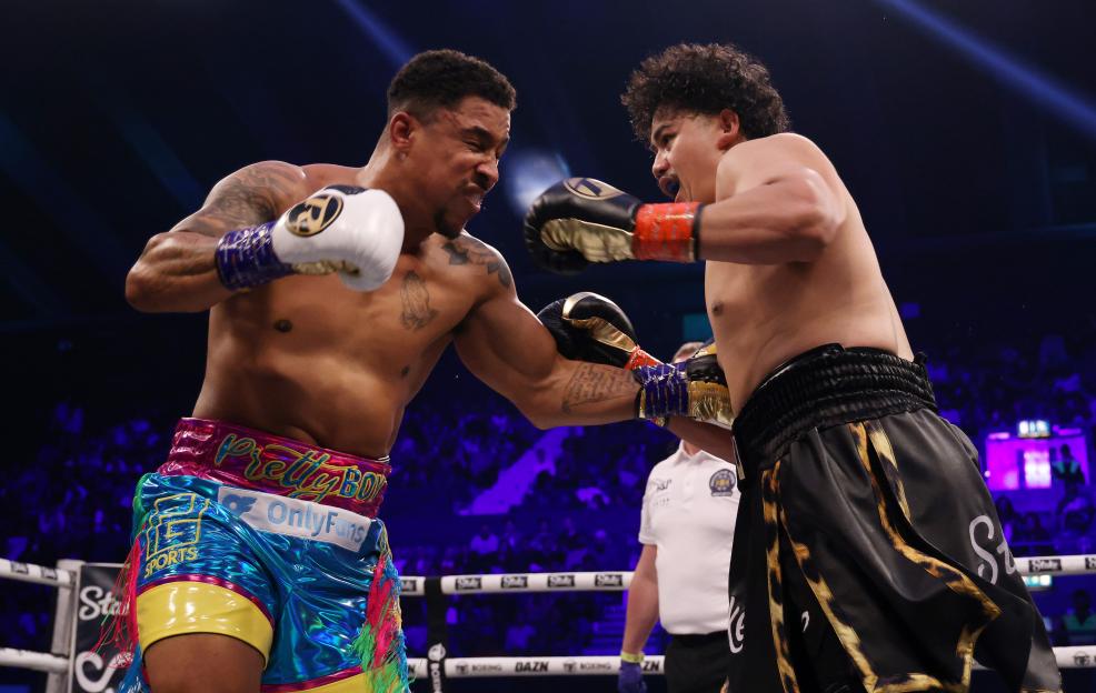 Boxers Salt Papi and Anthony Taylor exchanging punches in a boxing match.