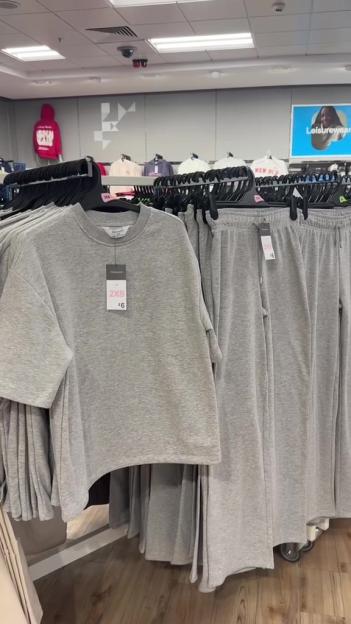A gray t-shirt and sweatpants co-ord set displayed in a store.