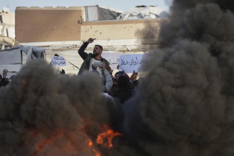 FILE- Palestinians chant slogans during a protest against the war and Hamas in Beit Lahiya, northern Gaza Strip, Wednesday, March 26, 2025, in a rare show of public anger against the militant group that rules the territory. (AP Photo/Jehad Alshrafi, File)