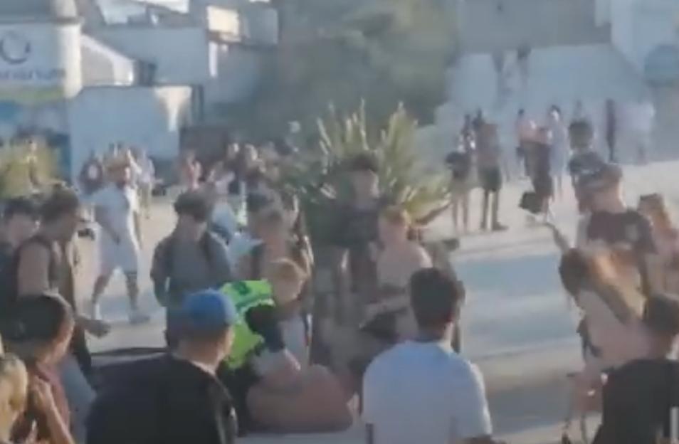 Mass brawl on a beach.
