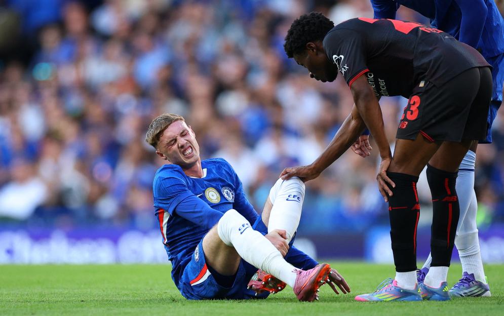 Chelsea's Cole Palmer with a leg injury during a soccer match.