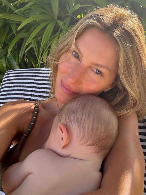 Gisele Bündchen holding a baby.