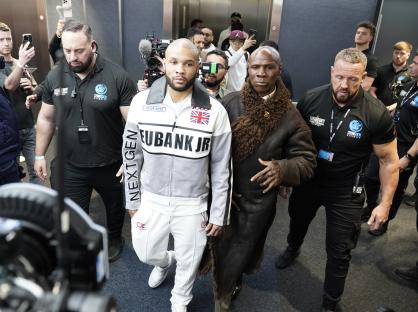 Chris Eubank Jr. and Chris Eubank Sr. walking together.