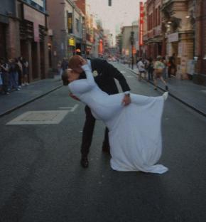 A plus-size bride and groom kissing on their wedding day.