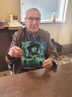 Michael McStay holding a signed Doctor Who print.