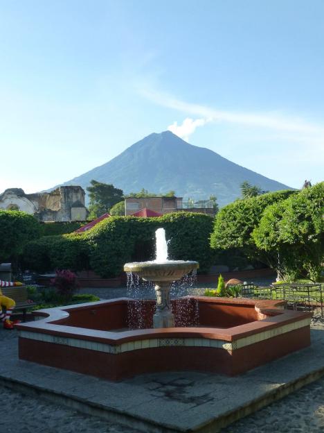 Fountain with a volcano in the background.