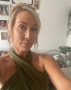 Selfie of a woman wearing a green halter top.